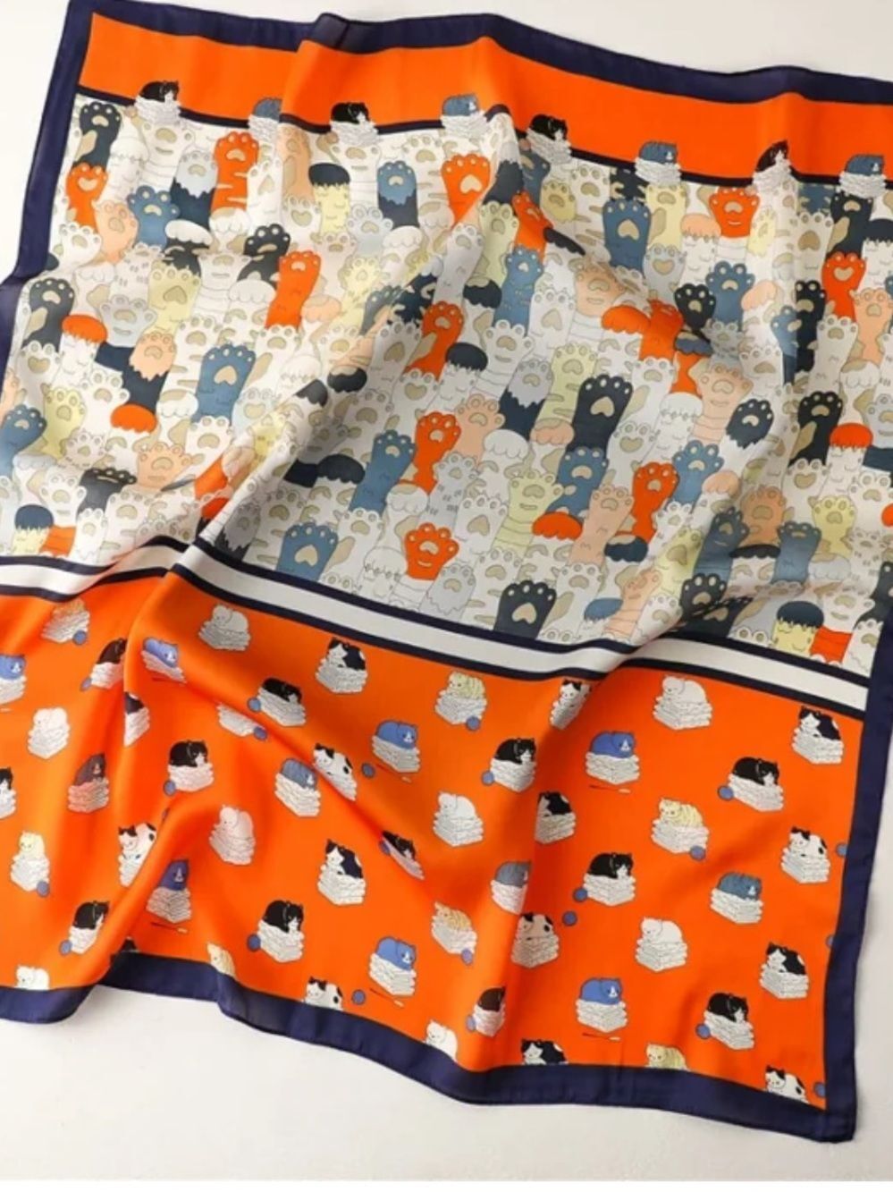 Playful Cat Paw Scarf in Orange & Navy feels like silk is polyester